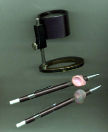 Tools of a Latent Print Examiner... magnifying glass and picks
